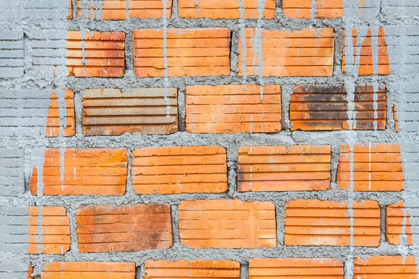 Closeup orange horizontal textured brick with dry concrete stain — Stock Photo, Image