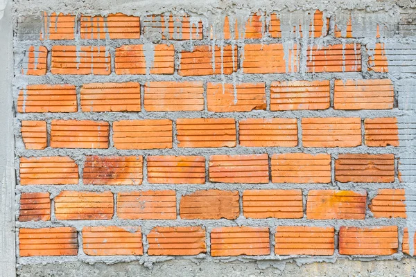 Closeup orange horizontal textured brick with dry concrete stain — Stock Photo, Image