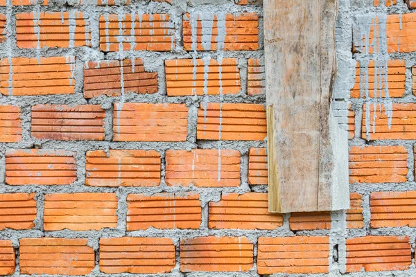 Closeup orange horizontal textured brick with dry concrete stain — Stock Photo, Image