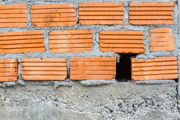 Closeup orange horizontal textured brick with dry concrete stain — Stock Photo, Image