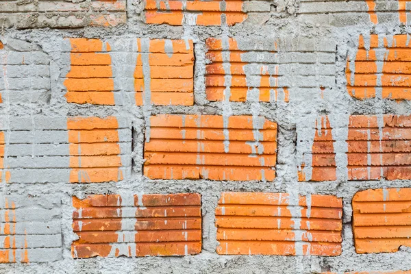 Closeup orange horizontal textured brick with dry concrete stain — Stock Photo, Image