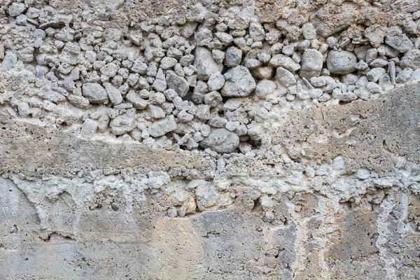 Nahaufnahme raue Betonwand mit Struktur aus Kieselsteinen — Stockfoto
