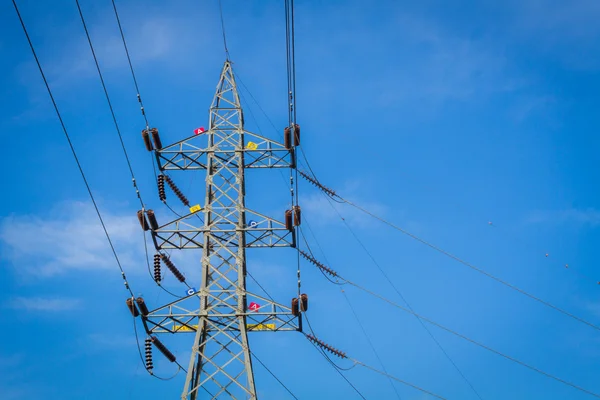 High voltage tower with English alphabet on the tower, blue clou — Stock Photo, Image