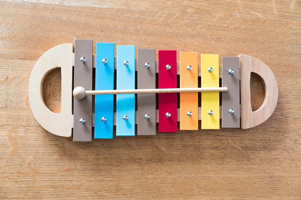 Mullticolored xylophone on a wooden background — Stock Photo, Image