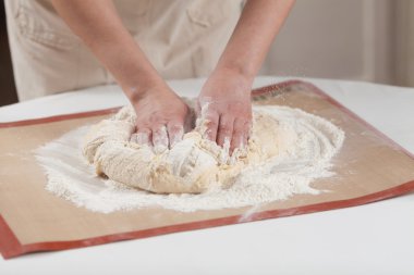 Making dough by hands at bakery clipart