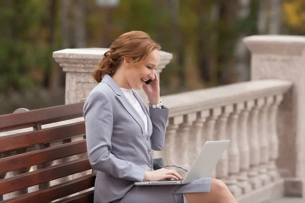 Laughing business women with laptop