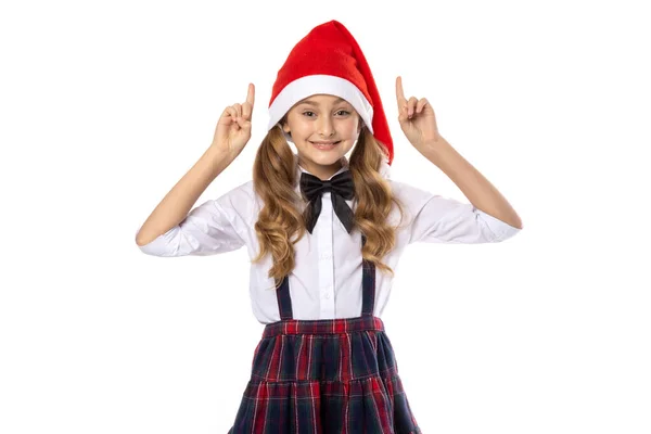 Little Girl Santa Claus Hat Points Her Fingers Blank Space — Stock Photo, Image