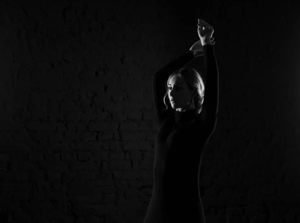 Black and white photography silhouette of a dancing woman.