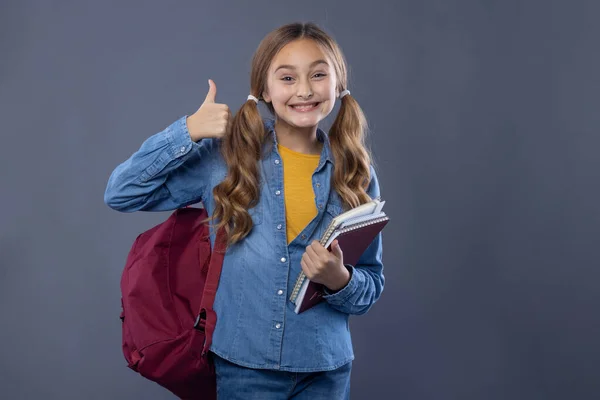 Écolière Fille Avec Manuels Montre Pouces Vers Haut Photo Studio — Photo