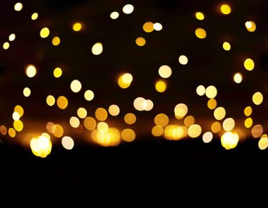 Koyu arkaplanda tatil sarısı altın bokeh. Noel ışığı ya da uçan fener festivali.