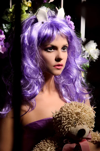 Anime young woman in purple wig with toy — Stock Photo, Image