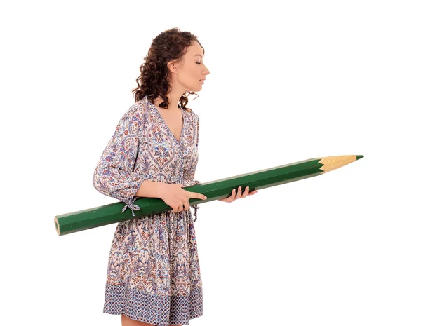 Young attractive woman with giant green pencil — Stock Photo, Image