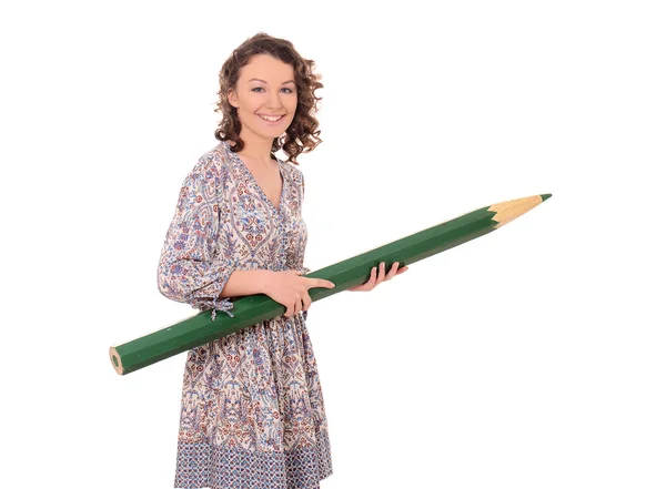 Young smiling woman with huge green pencil — Stock Photo, Image