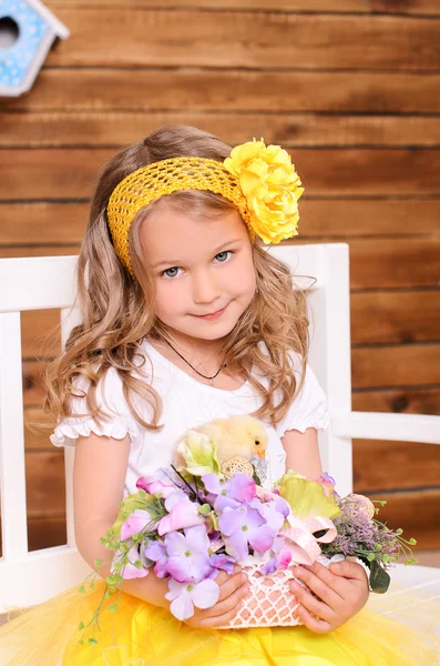 Cute little girl with flowers and alive chicken — Stok fotoğraf