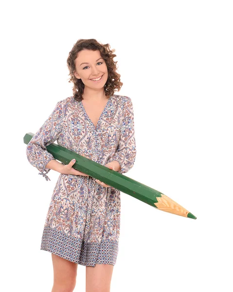 Young smiling woman with huge green pencil — Stock Photo, Image