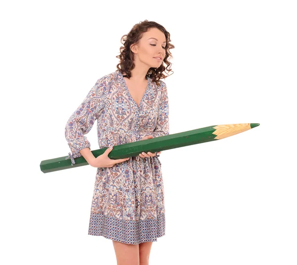 Young attractive woman with giant green pencil — Stock Photo, Image