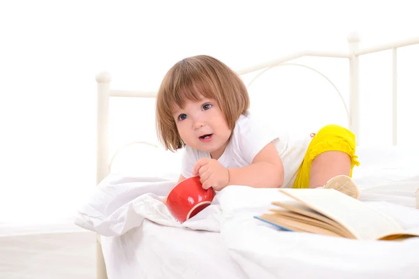 Baby girl on white bed