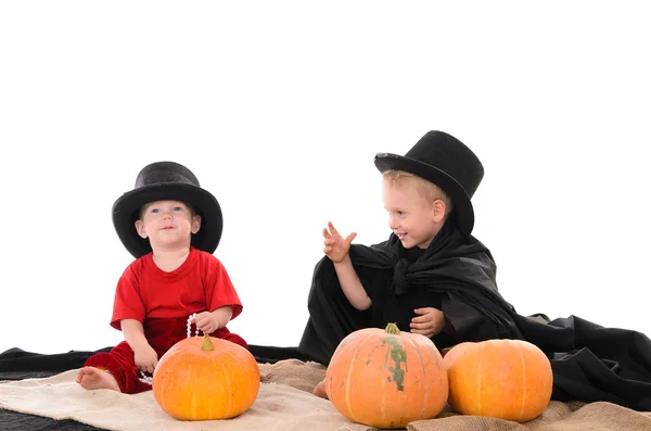 Two brothers in Halloween costumes with pumpkins — Stock Photo, Image