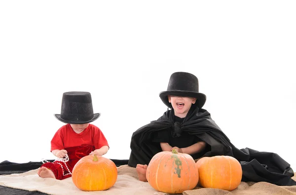 Two kids in Halloween costumes with pumpkins — Stock Photo, Image