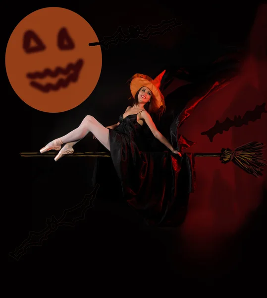 Attractive Halloween witch on broom — Stock Photo, Image