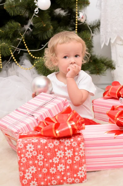 Little girl with boxes of presents — Stock Photo, Image