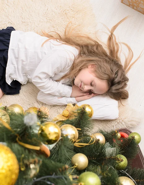 Girl sleeping at christmas tree — Stock Photo, Image