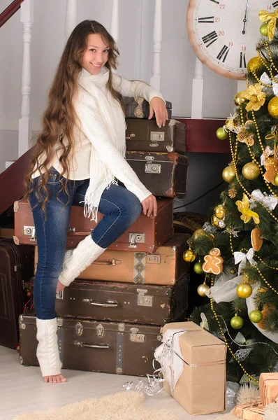 Девушка с чемоданами в рождественском интерьере — стоковое фото