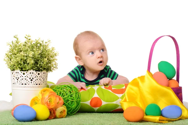 Baby with easter colored eggs — Stock Photo, Image