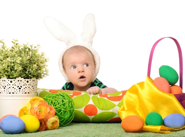 Baby with easter colored eggs — Stock Photo, Image