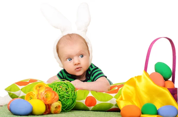 Baby with easter colored eggs — Stock Photo, Image