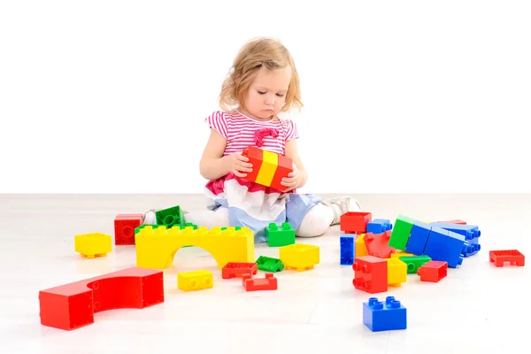 Little girl playing with colorful blocks — Stock Photo, Image