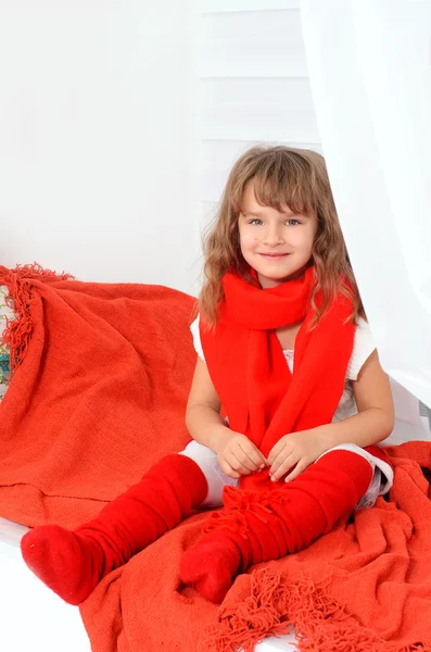 Little girl in red and white indoors — Stock Photo, Image