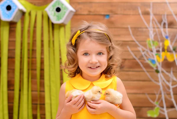 Little girl with chickens indoors — Stock Photo, Image