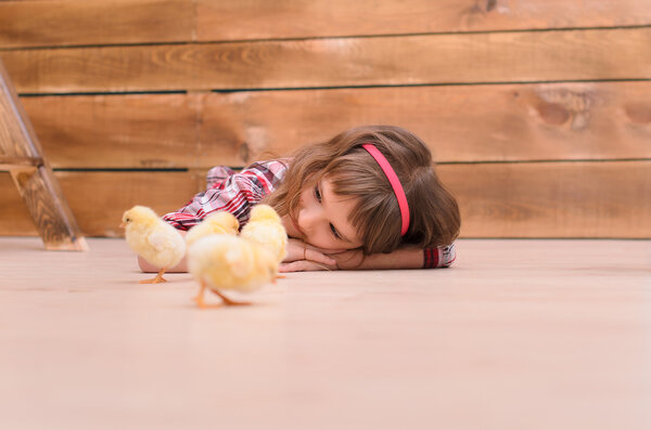 Girl lying on floor and watching for chickens