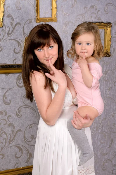 Funny mommy holding her little daughter — Stock Photo, Image