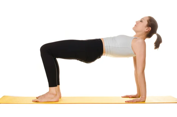 Mujer joven practicando ejercicios de yoga —  Fotos de Stock