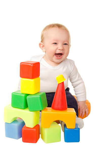 cheerful baby boy playing with colorful blocks