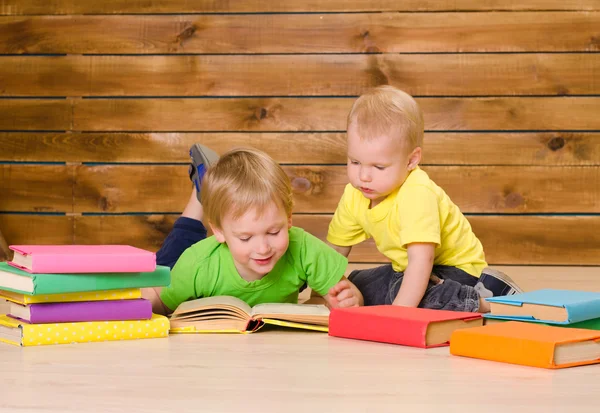 Two little brothers reading books indoors — Stock Photo, Image