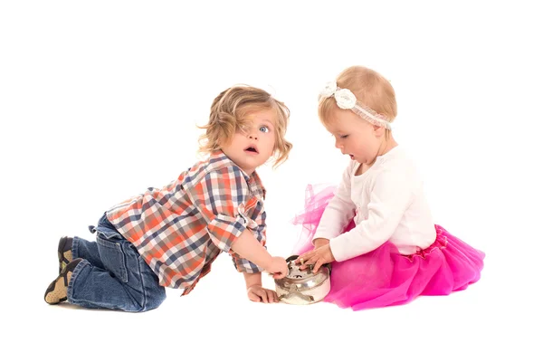 Little boy and girl playing with alarm clock — Stock Photo, Image