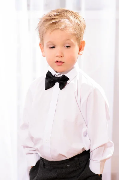 Blond boy in white shirt with black bow tie — Stock Photo, Image