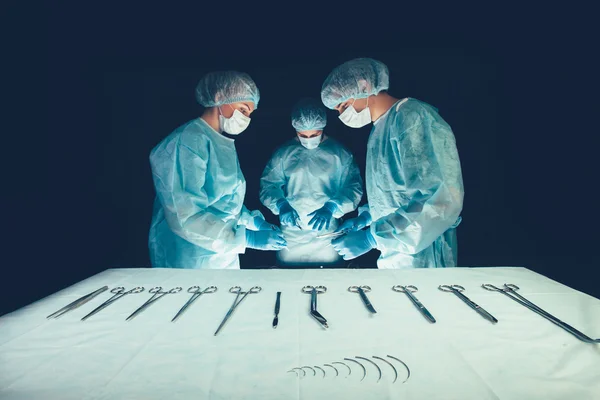 Medical team  hospital performing operation. Group of surgeon at work in operating theatre room. healthcare . — 图库照片