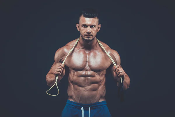 Muscular man skipping rope. active  sport  fitness — Stok fotoğraf