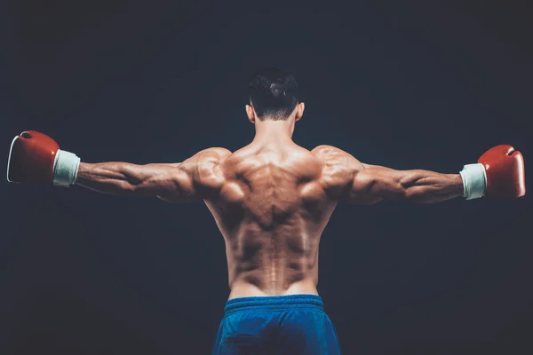 Muscular boxer in studio shooting, on black background. — Stock Photo, Image