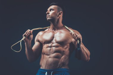 Muscular man skipping rope. active  sport  fitness