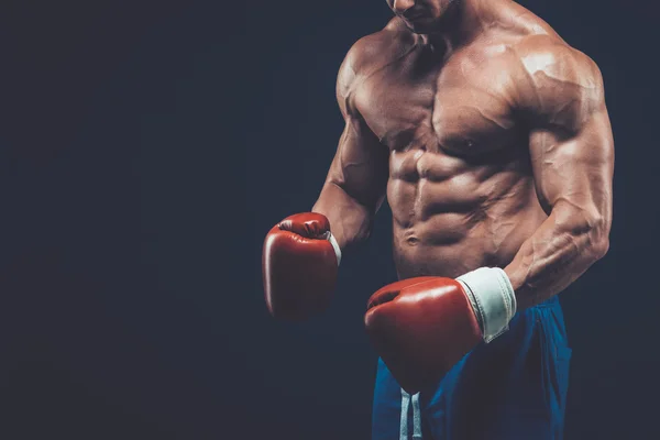 Muskulöser Boxer im Studio, auf schwarzem Hintergrund. — Stockfoto