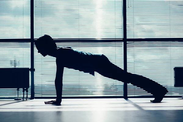 Fitness, sport, training and people concept - smiling woman doing abdominal exercises on mat in gym contour of the body against the window — Stock Photo, Image