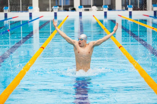 Dynamic and fit swimmer in cap breathing performing jumping out the water, concept of victory, freedom, happiness, healthy lifestyle — Stock Photo, Image