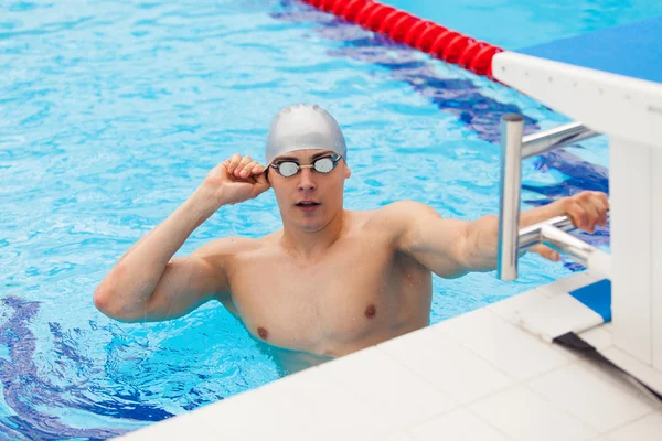 Young man in a pool - go to start swimming. backstroke during — Stock Photo, Image