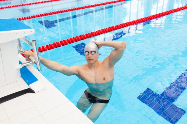 Young man in a pool - go to start swimming. backstroke during — Stock Photo, Image