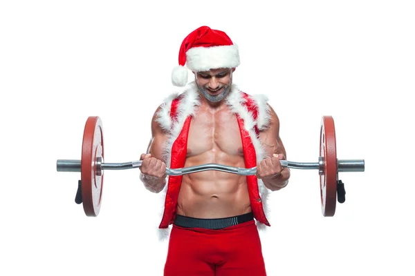 Babbo Natale sexy. Culturista giovane bello Babbo Natale clausola sorriso in rosso Babbo Natale treno muscoli braccia e bicipiti a Capodanno e Natale vacanza invernale sfondo bianco. — Foto Stock